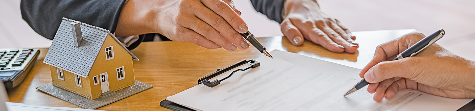 People signing paperwork